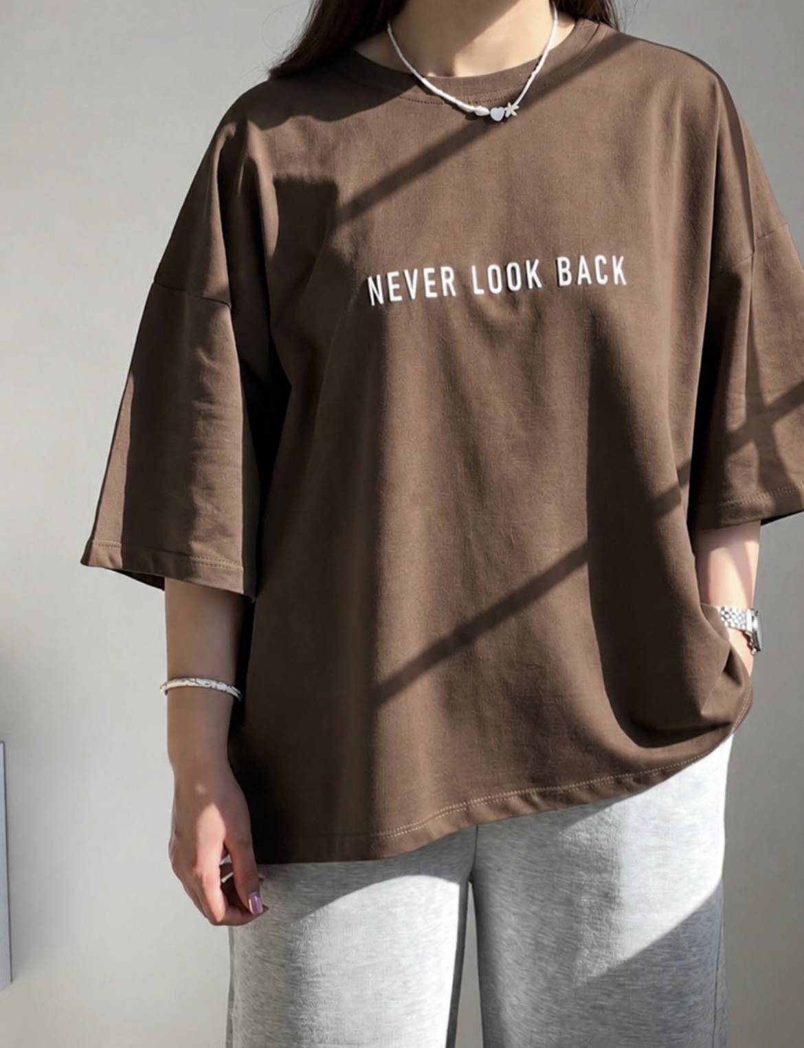 تیشرت باکسی طرح Never Look Back - زاویه از پایین لباس برای دیدن قد و فرم